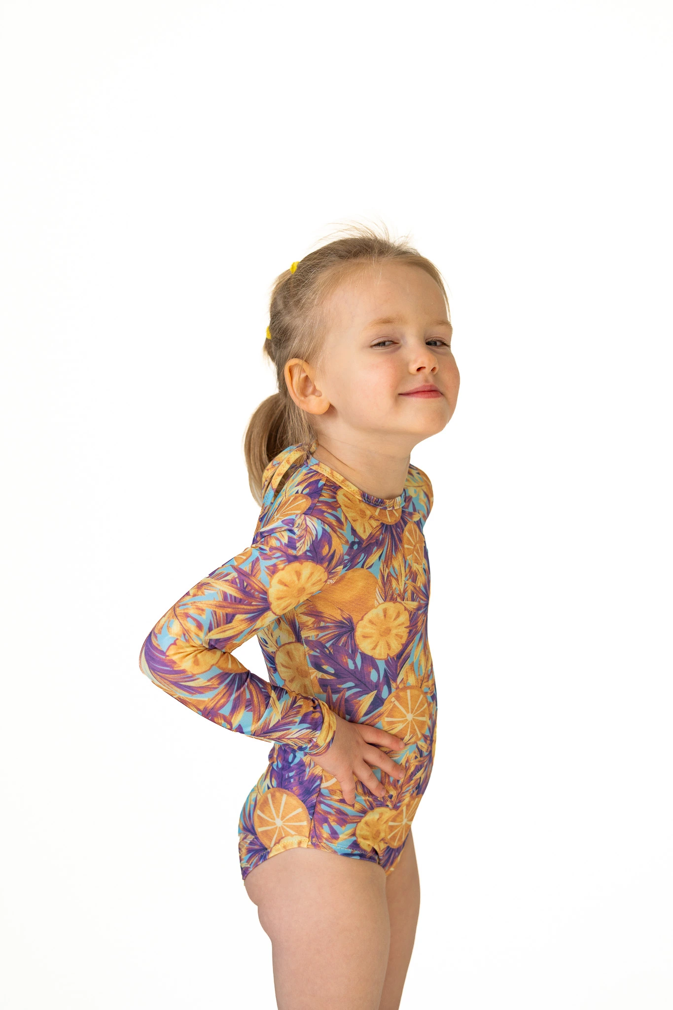 Z20 Lemon paradise Children's long-sleeve tan-through one-piece swimsuit in orange and purple floral print, side view